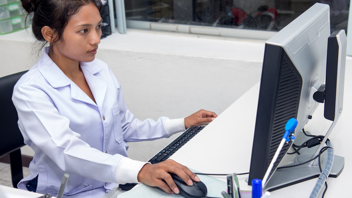 A healthcare employee works at her computer.